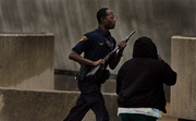 A Cleveland police officer runs into SuccessTech Academy in Cleveland, Ohio, Wednesday, Oct. 10, 2007. after shooting inside. Mayor Frank Jackson said three young people and two adults were hurt by a student who turned the gun on himself. (AP Photo//The Plain Dealer, Gus Chan)